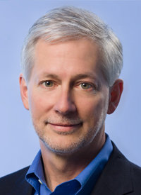 Mature businessman smiling in blue jacket