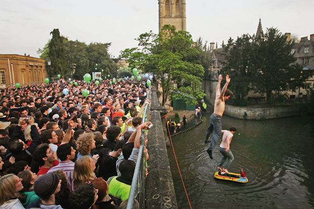 Man jumping into river during lively outdoor public event