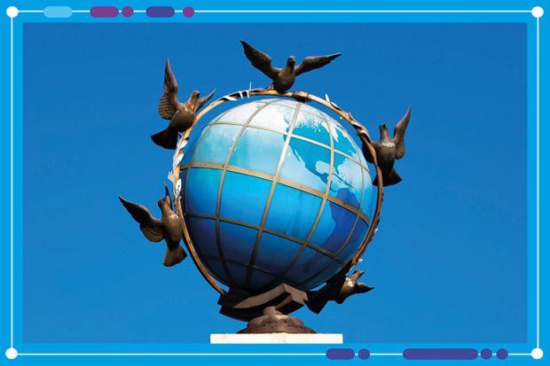 Birds flying around a blue globe sculpture against sky