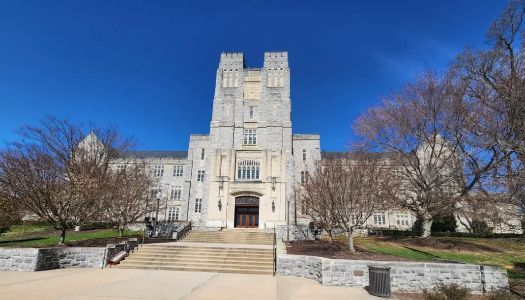 Historic stone building with a tower under blue sky